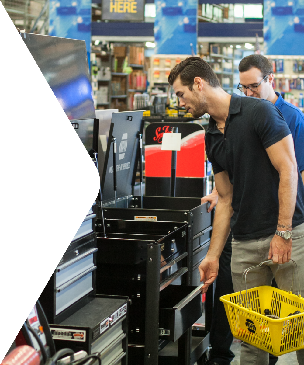 A NAPA employee assisting a customer with locating products around the store.